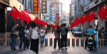 Street with Chinese national flags in a business district — illustrating CIETAC arbitration clause considerations for Ukrainian companies entering contracts with Chinese counterparties