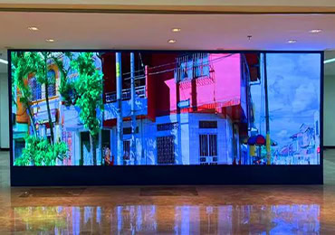 FinCOB P1.25 fine pitch COB LED display showing colorful street scene in indoor lobby in Singapore
