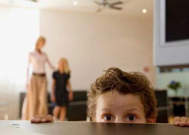 A frightened child looks over the counter - fear of CPS or CHFS concept