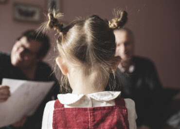 Rear view of girl with braids and grandparents in background