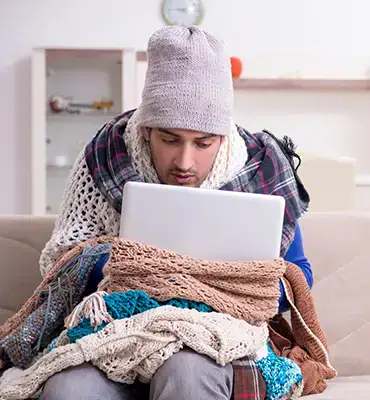 man freezing in his home