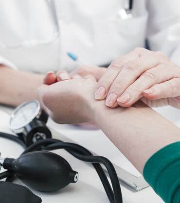 doctor-s-hand-tending-patient