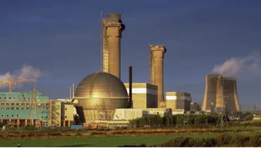 Nuclear power plant with cooling towers generating energy for the nuclear industry