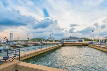 Engineers inspecting water treatment facility with pipelines and filtration systems