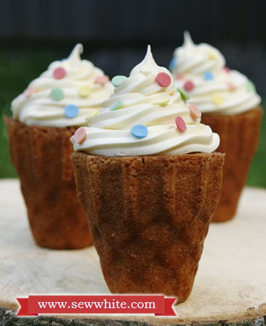 ice cream cone cakes decorated with swirl buttercream and sprinkles