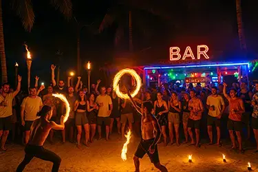 Beach party in Boracay with fire dancers and sunset backdrop