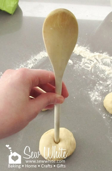 Using a wooden spoon to create the holes in the centre of the bagels. Home Made Bagel Recipe