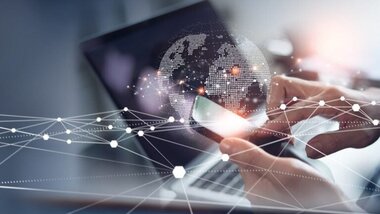 smartfon, człowiek, dokonujacy przelewu, laptop, na ekranie mapa świata