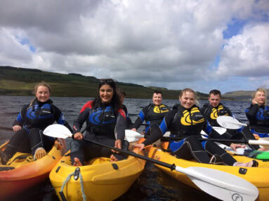 A group kayaking at Dunlewey Lake
