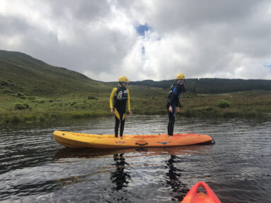 A young group kayaking in Dunlewey Lake