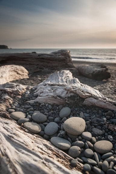 Counseling for therapists: pebbles along the beach at sunset
