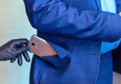 person stealing someone's phone out of their coat pocket