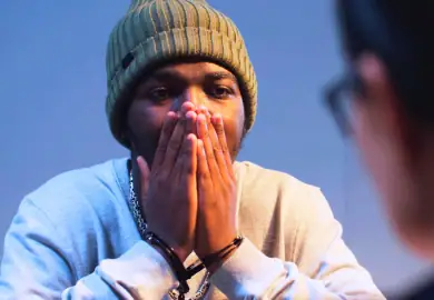 Distressed black American teenager with handcuff.