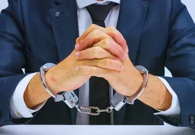 Guy in suit with handcuff.