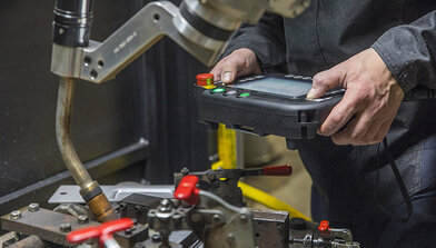 Weld operator with teach pendant and robotic MIG welding gun