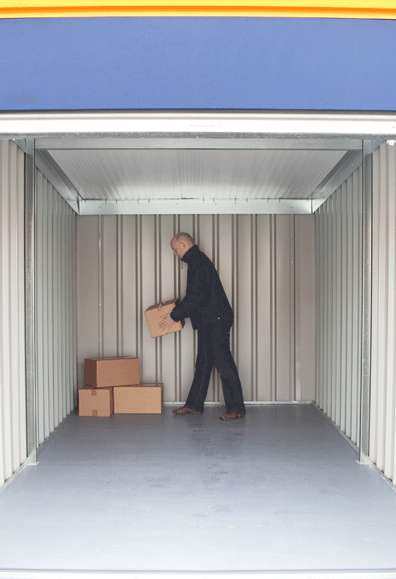 Person putting boxes into storage unit