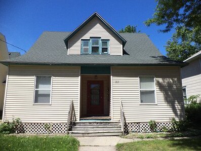 A single-family home with 5 windows and whjte panelling