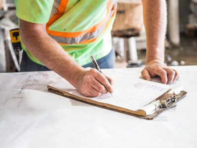 construction worker going over a checklist
