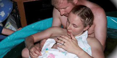 Woman giving birth at home