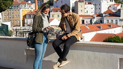 couple in portugal looking at map