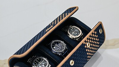 A watch case with 3 watches
