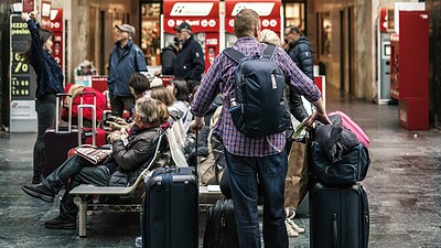 person standing beside luggage