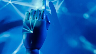 robot s hand on a blue background