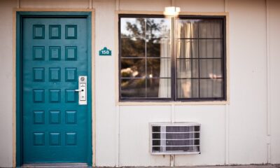 teal wooden door beside window