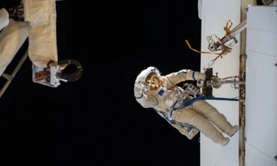 "Two cosmonauts conducting a spacewalk outside the International Space Station"
