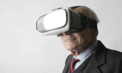 senior man using vr goggles in studio