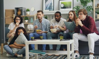 friends sitting on couch and watching movie