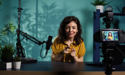 happy online show host hitting the record on professional camera using microphone to t SBI 351237180