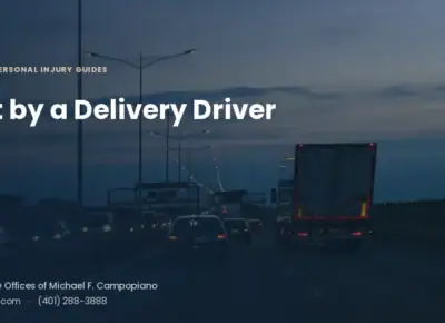 A box truck traveling with traffic on a multi-lane highway at dusk