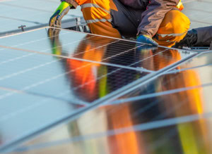 technician installing solar panels