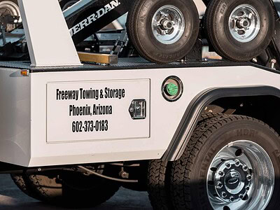 Freeway Towing & Storage wheel-lift tow truck with company logo