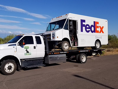 FedEx delivery van being towed by Freeway Towing in Phoenix