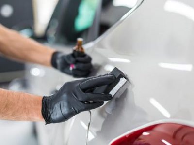 nano coating Car detailing - Man applies nano protective coating to the car. Selective focus.