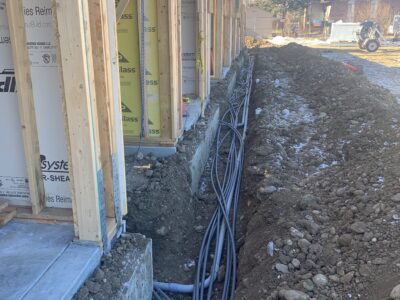 Electrical conduit placed into excavated trench for electrical contractor as part of larger construction project in Adams County, Colorado