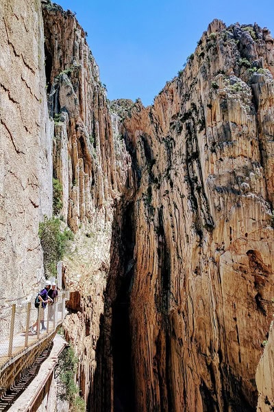 Hikers walking on the cliffside wooden boardwalk of Caminito del Rey gorge during an exclusive VIP adventure tour