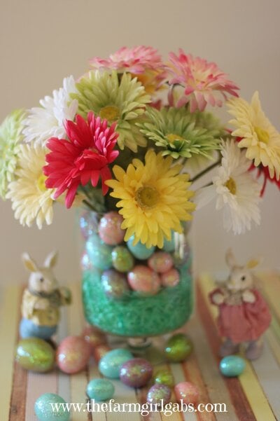 This beautiful spring centerpiece is easy to make and inexpensive too. Learn easy steps to make this colorful spring arrangement. It's perfect for Easter!