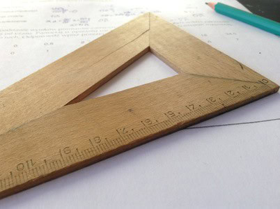 Ruler and pencil for precise measurement on paper.