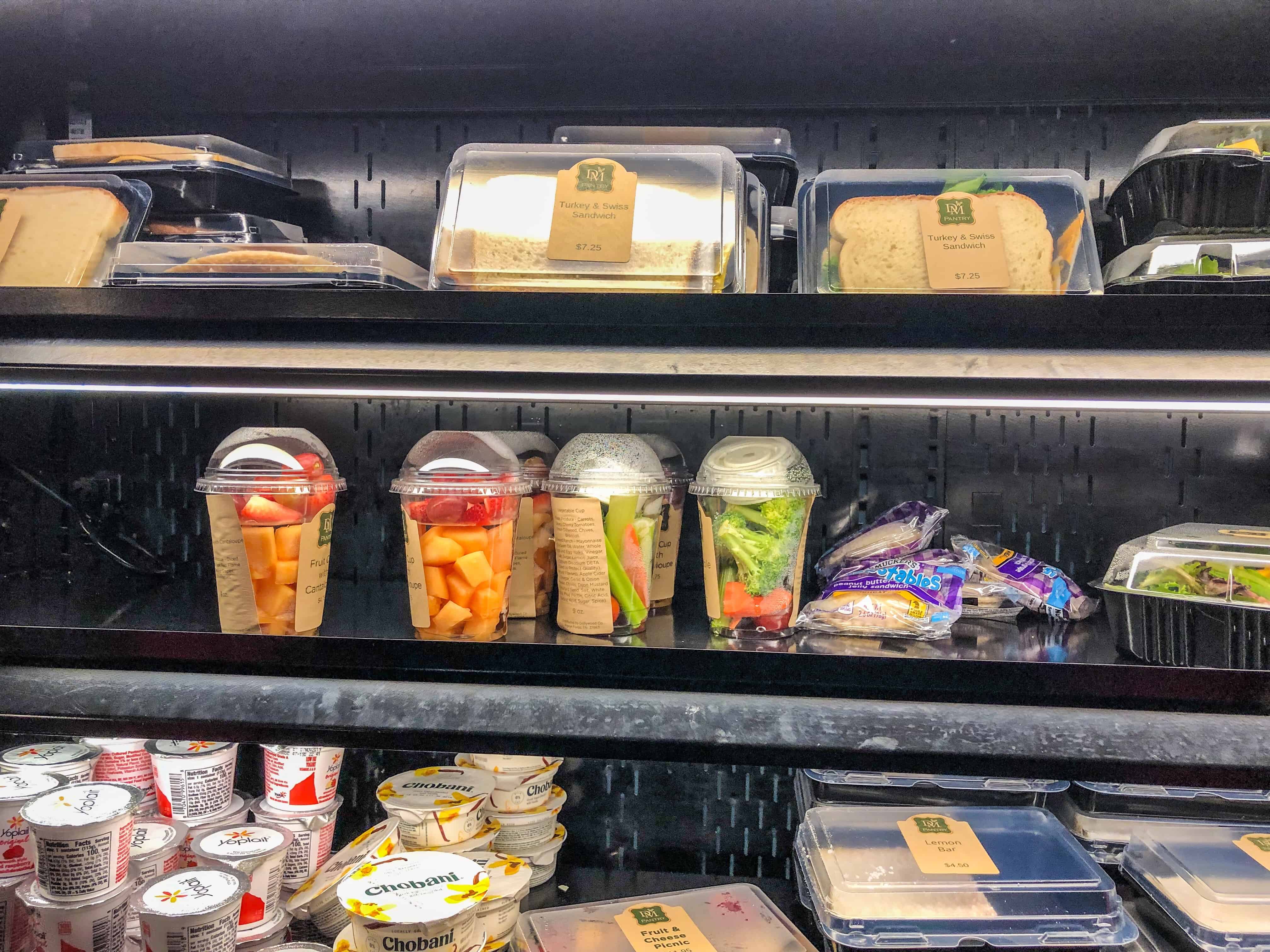 DM Pantry grab and go items like yogurt, fruit, vegetables, and sandwiches