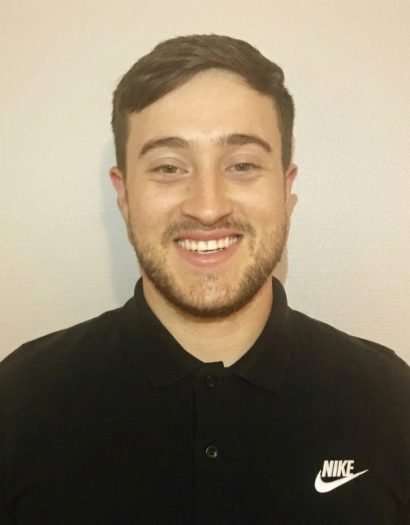 Caleb smiling in a black Nike shirt.