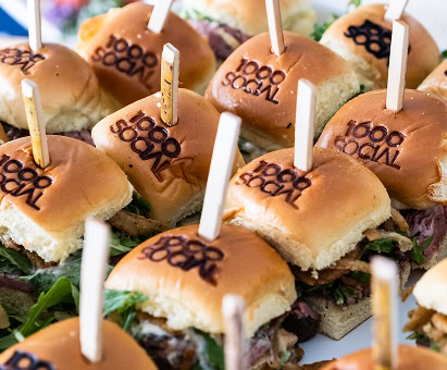 A tray of sliders branded with "1000 Social" a luxury Raleigh office space