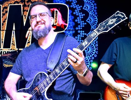 James Brennaman playing a Sea Smoke Gibson Les Paul Supreme during a 2025 performance with AMP, the Alanis Morissette Project.