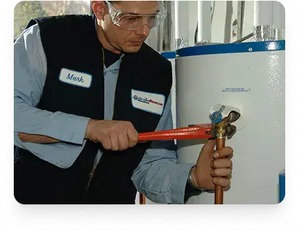 Servicing a water heater connection with a pipe wrench in Etobicoke by Drain Rescue Plumbers