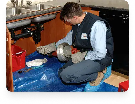 Unclogging a kitchen sink using a hand auger in Etobicoke by Drain Rescue Plumbers