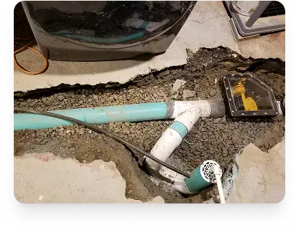 Etobicoke pipe replacement showing a repaired underground joint in broken concrete