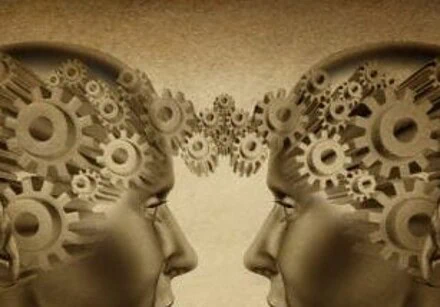 Business partnership and teamwork symbol represented by two human heads with gears connected together as a symbol of network referrals and relationships on an old grunge parchement background.