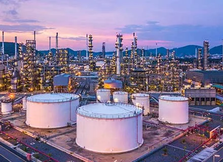 Oil refinery with pipelines and storage tanks representing the oil and gas industry